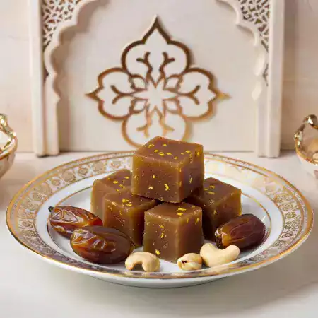 Traditional Rajasthani date halwa dessert prepared using EcoDateFarm's premium Medjool dates from Jaisalmer, rich and aromatic sweet dish